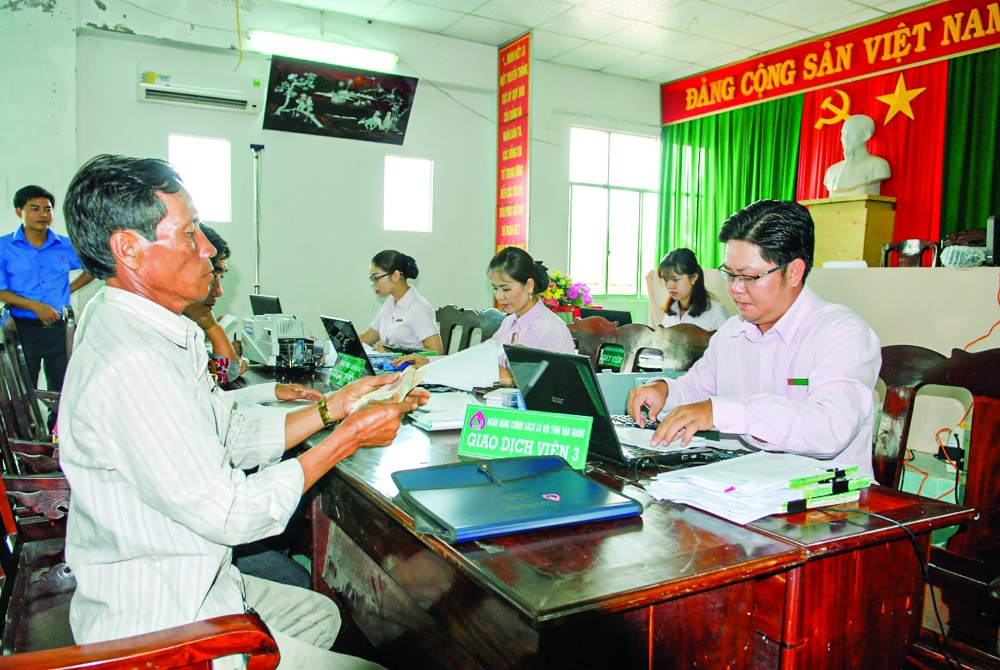 Cán bộ NHCSXH chi nhánh Hậu Giang giao dịch tại Điểm giao dịch xã